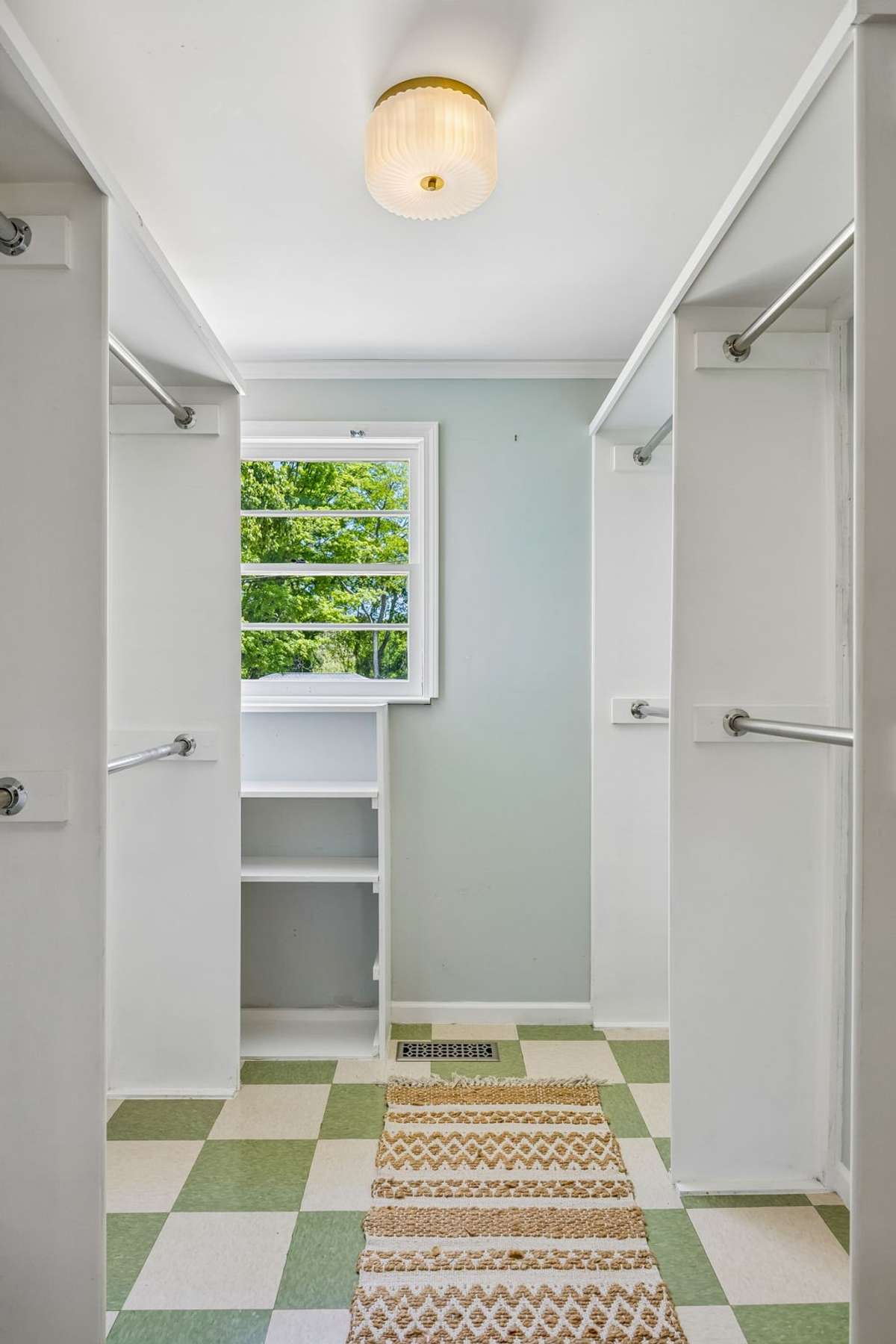 Tailored primary room walk-in closet.