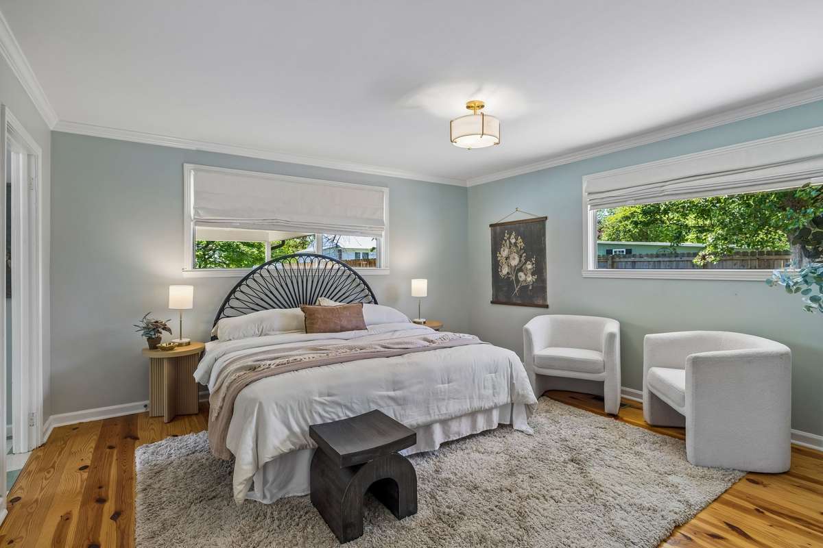 The primary bedroom serves as a private wing of the home, flooded with natural light. Highlights include a spacious walk-in wardrobe and a well-appointed full ensuite bath.