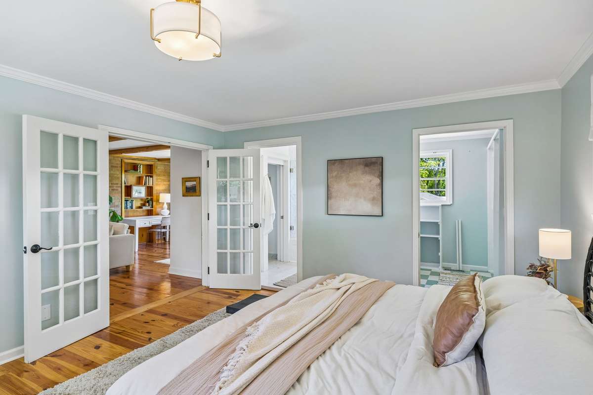 The primary bedroom serves as a private wing of the home, flooded with natural light. Highlights include a spacious walk-in wardrobe and a well-appointed full ensuite bath.