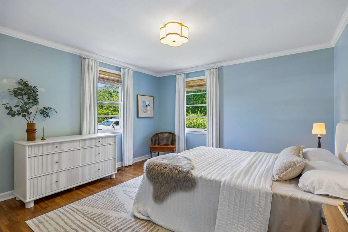 An impressively oversized secondary bedroom that offers plenty of space for a king-sized bed and a dedicated seating area or desk.