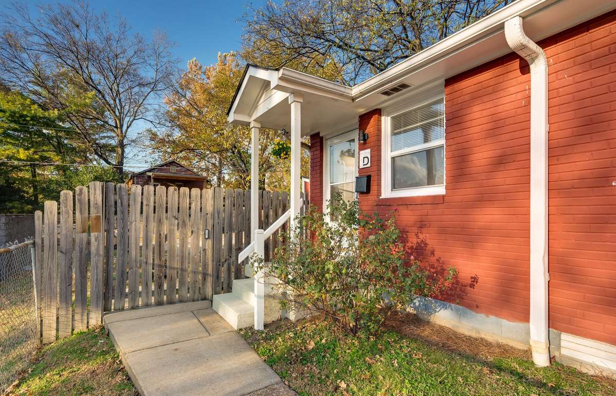 Unit D entry. Alley access parking and storage units through the gate.