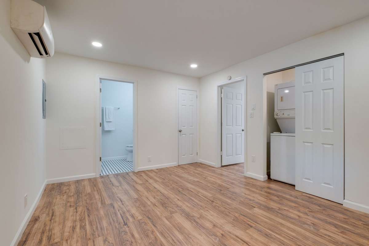 Unit C bedroom. Full bath ahead and washer/dryer to the right. 2 closets.
