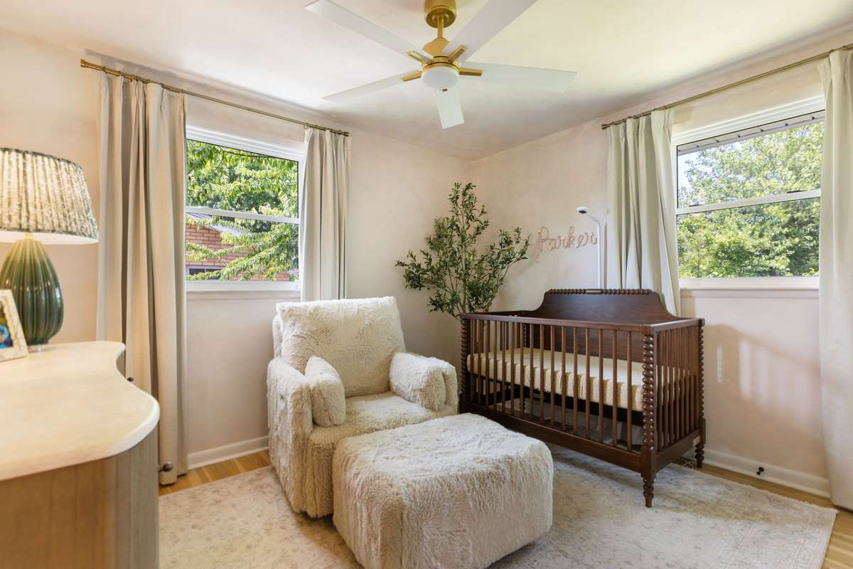 Bedroom #2 has textured painted walls, a ceiling fan, and lots of natural light.