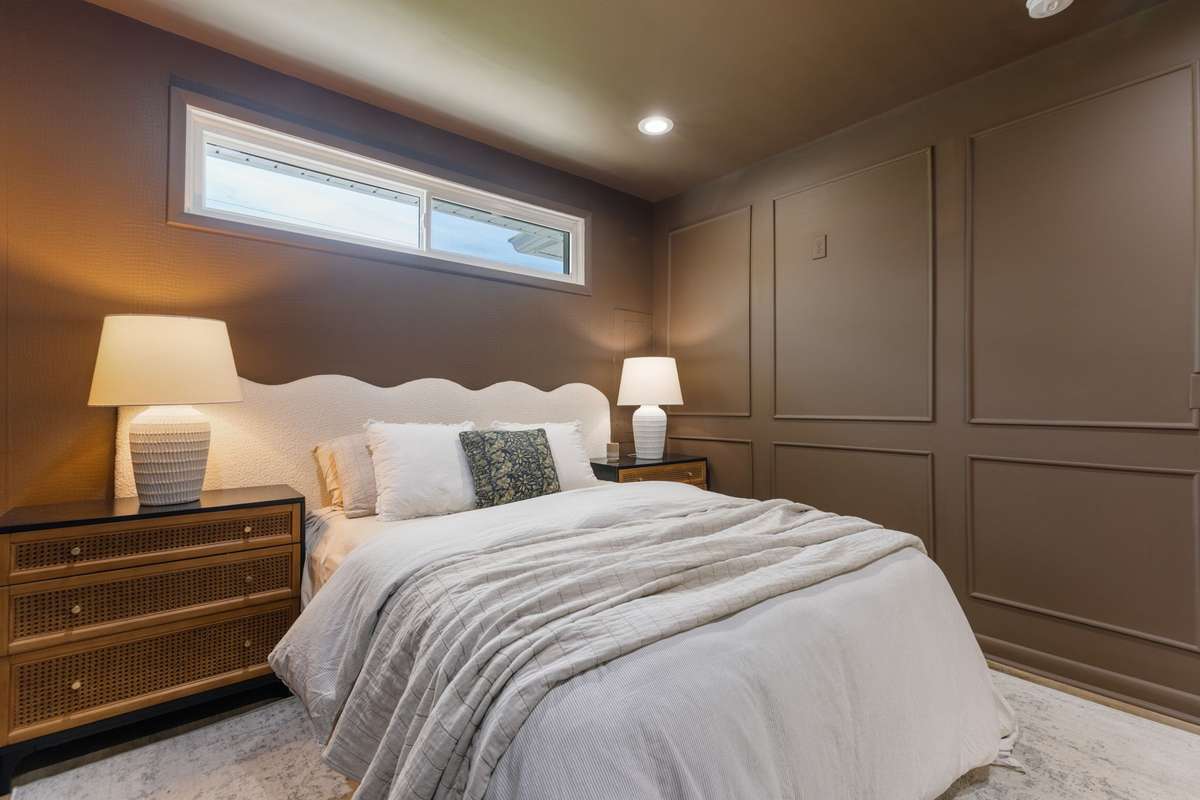 Private, primary bedroom situated on the opposite side of the home from the 3 secondary bedrooms. Primary bedroom with an elevated style including wainscoting trim, recessed lighting, and LVP flooring.