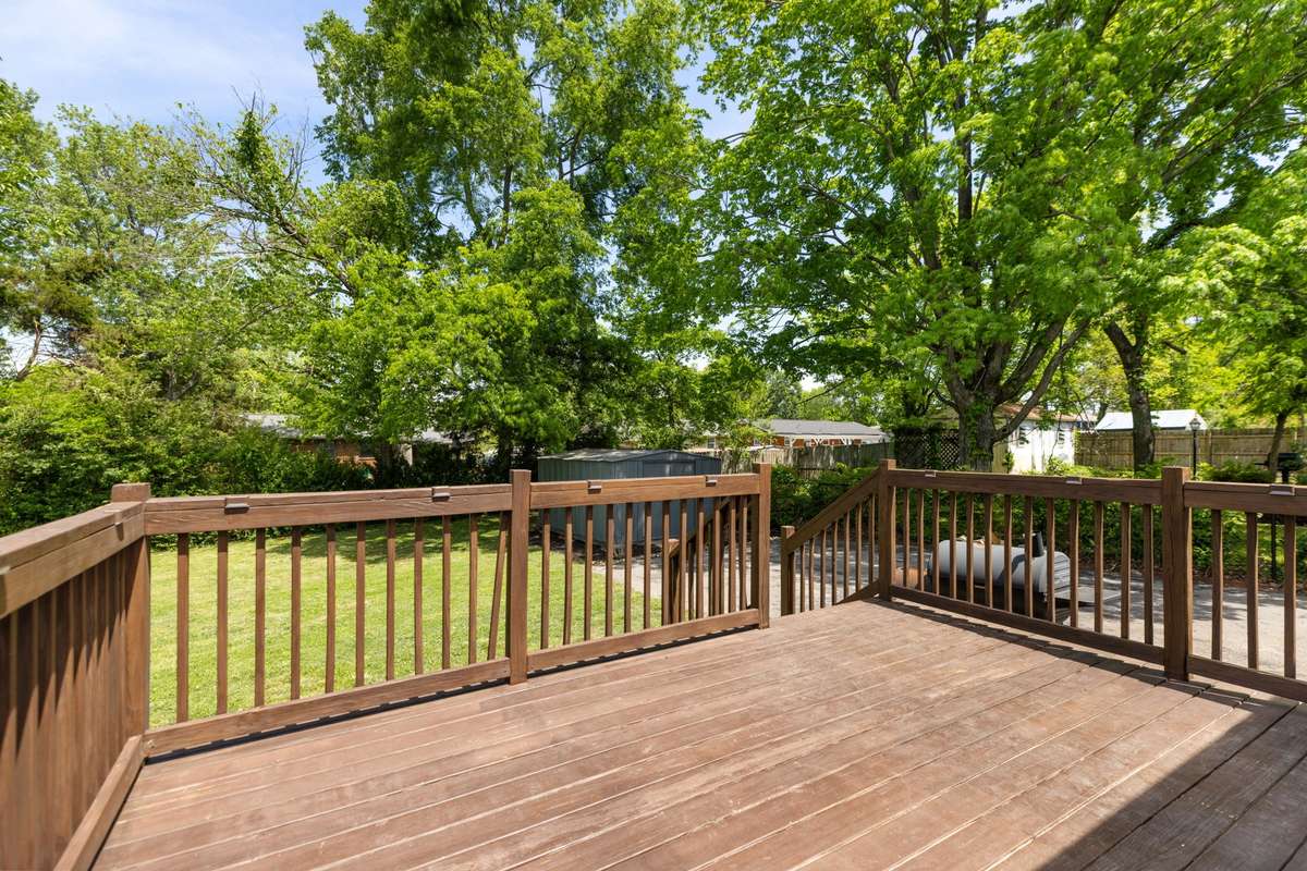 Large back deck opens to the level, fenced-in backyard.