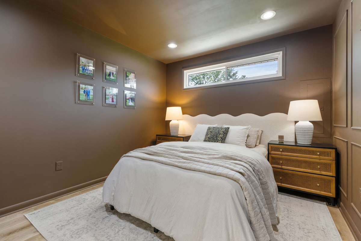 Private, primary bedroom situated on the opposite side of the home from the 3 secondary bedrooms. Primary bedroom with an elevated style including wainscoting trim, recessed lighting, and LVP flooring.