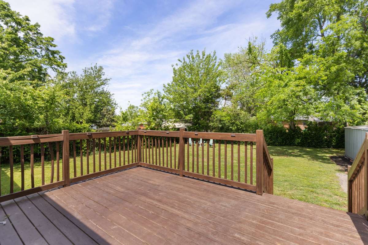 Large back deck opens to the level, fenced-in backyard.