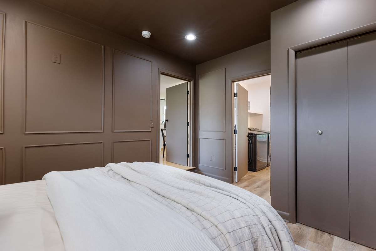 Private, primary bedroom situated on the opposite side of the home from the 3 secondary bedrooms. Primary bedroom with an elevated style including wainscoting trim, recessed lighting, and LVP flooring.