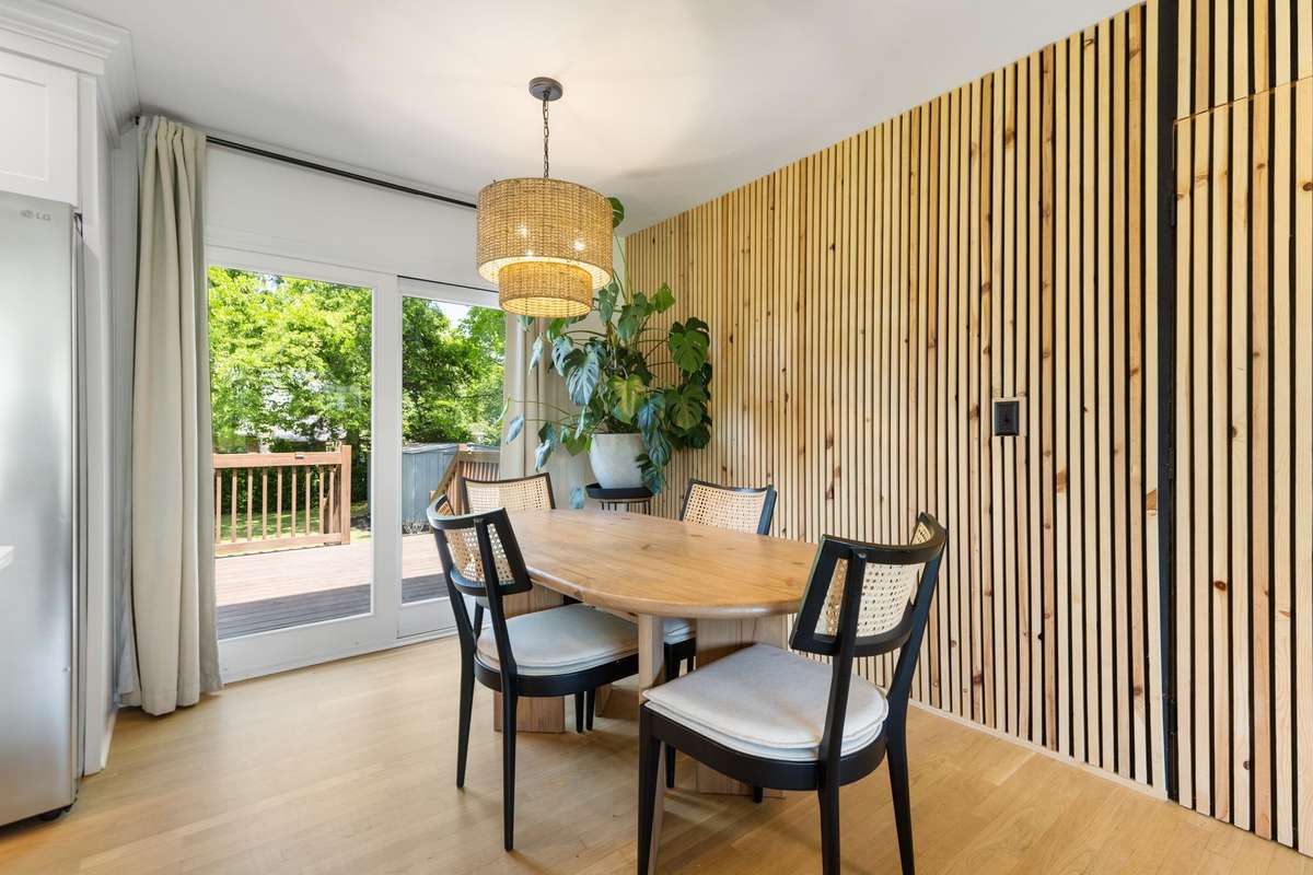 Beautiful dining space opens to the spacious back deck overlooking the level, fenced-in backyard.
