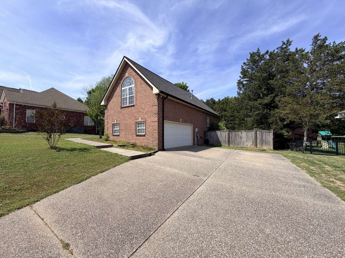 Oversized two car garage with aggregate driveway