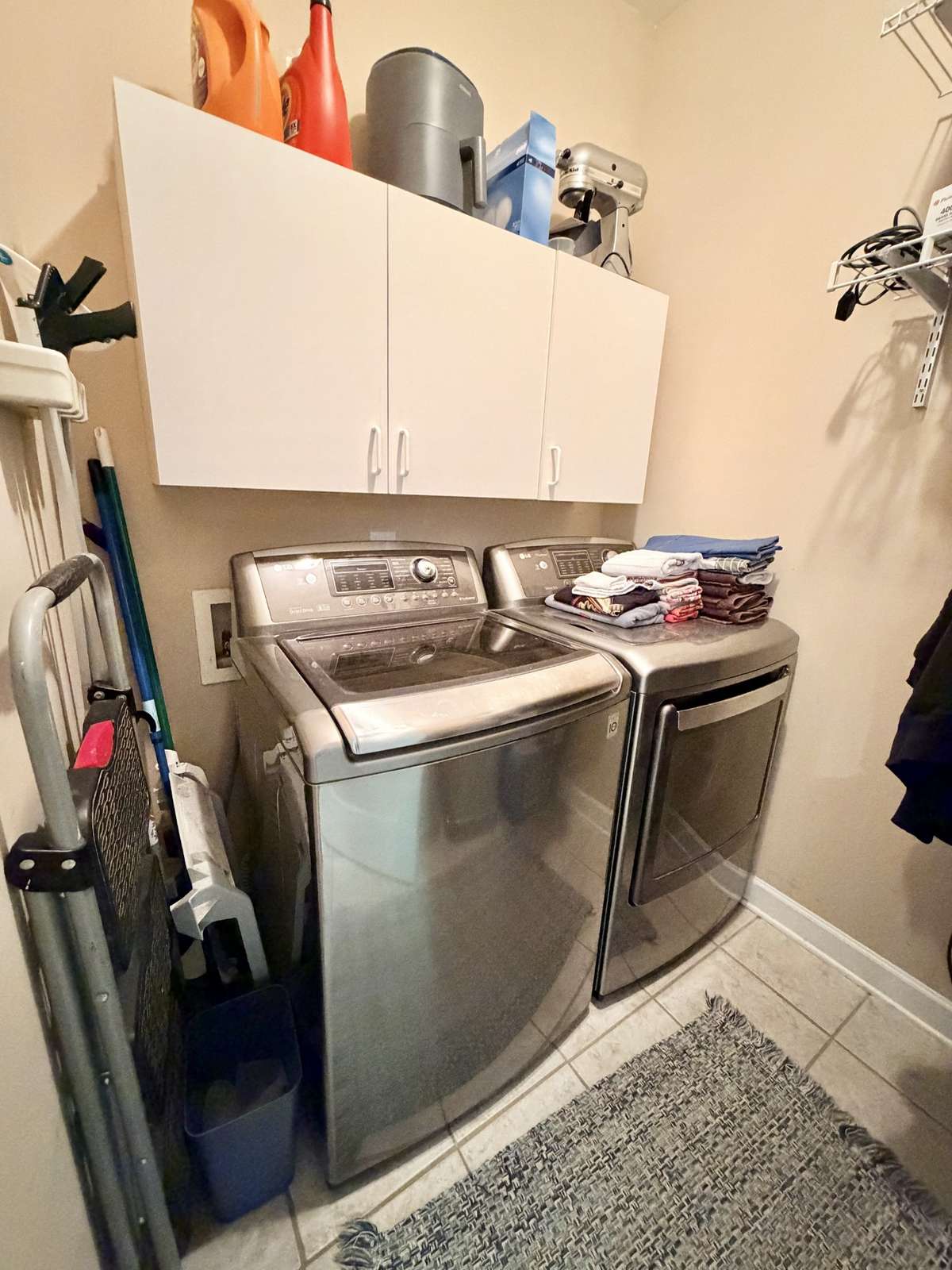 Designated laundry room with extra storage.