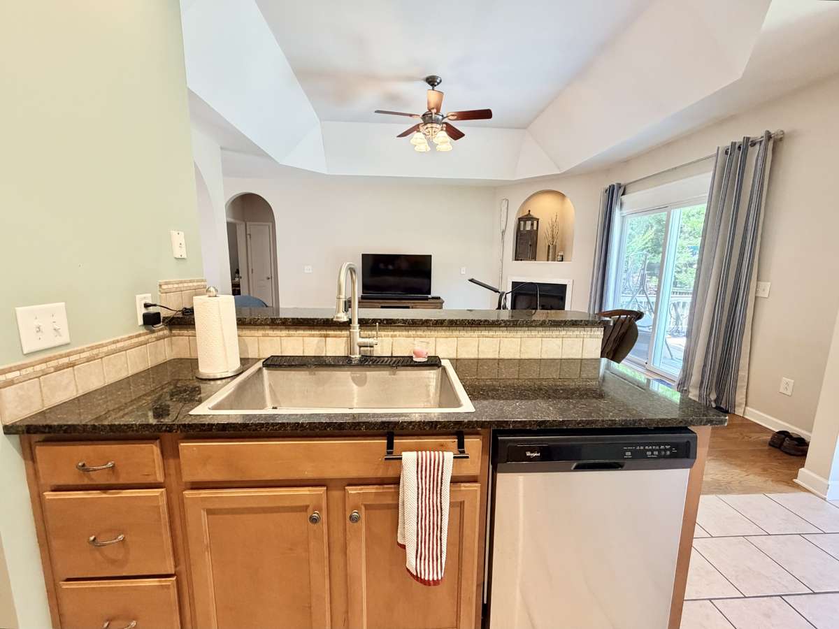Kitchen sink overlooks into living room. Wash the dishes while watching your favorite show!