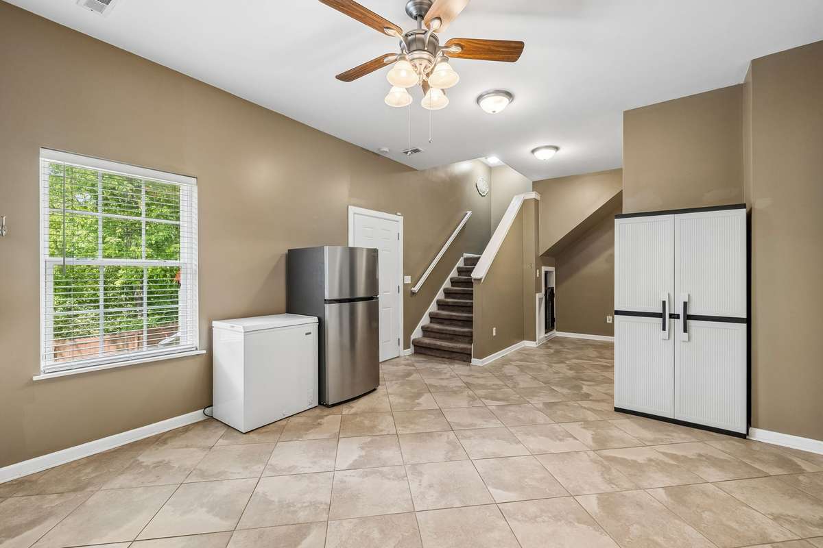 Finished basement entertainment area. This space could easily be converted to a kitchen for in-law quarters.