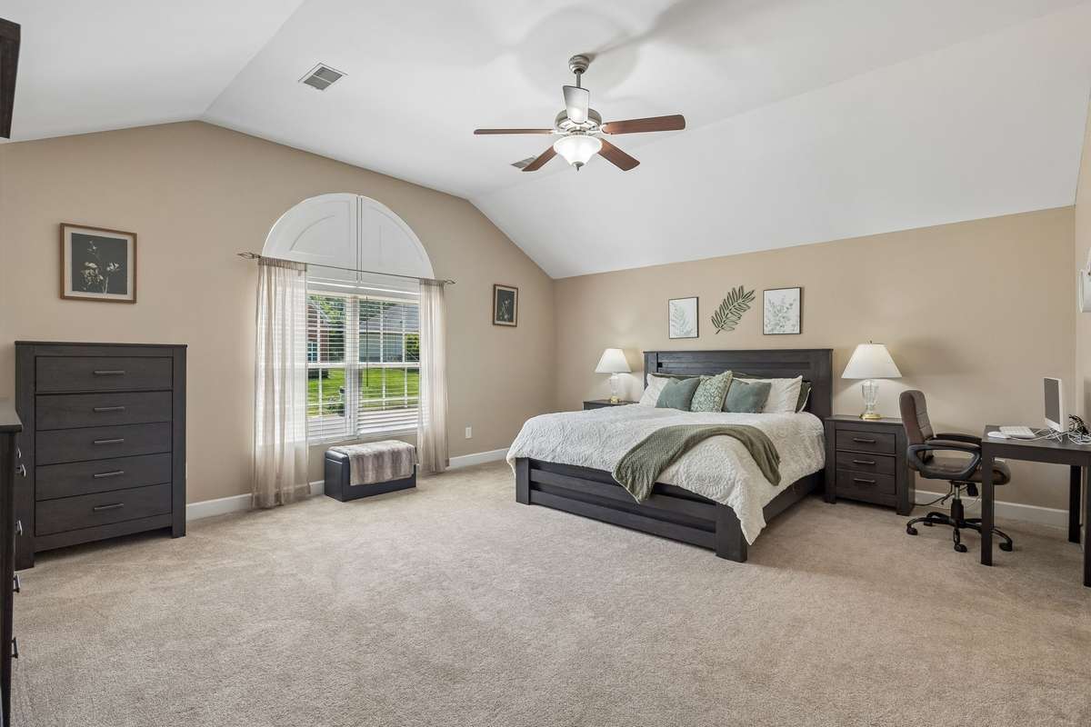 19x17 Primary bedroom has vaulted ceiling and gorgeous arched window.