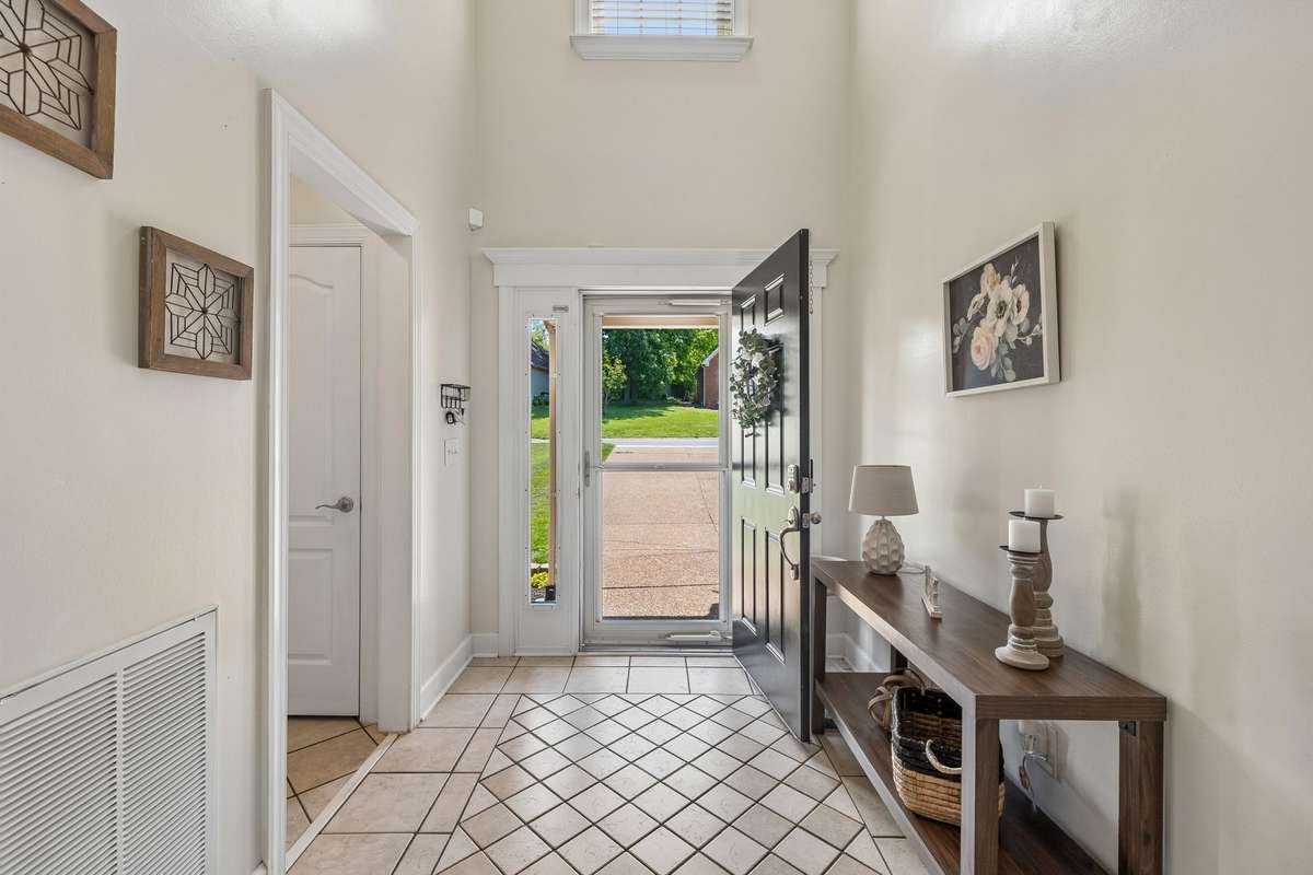 Large entry with tile floors and massive ceiling height.
