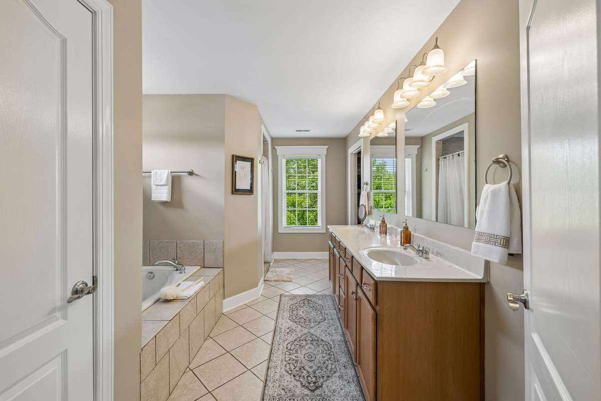 Spa like primary bathroom has a large soaking tub and massive shower.