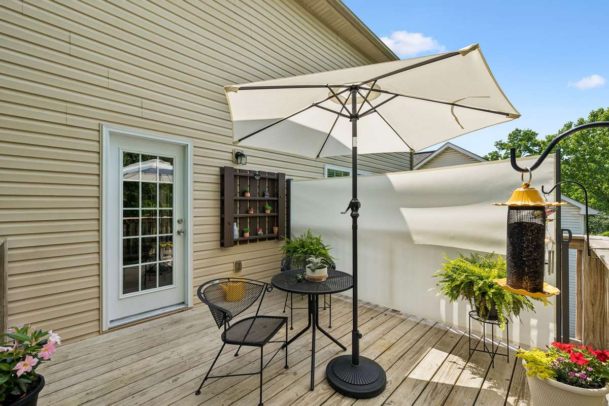 This is one of TWO decks. This is the upper deck with retractable privacy screen that doubles as an outdoor movie screen!
