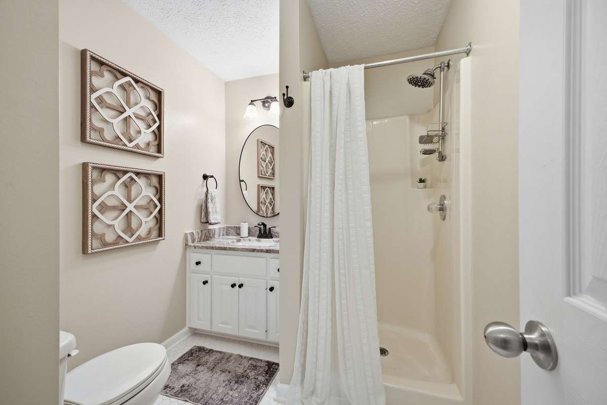 Hall/Guest Bathroom with walk in shower.