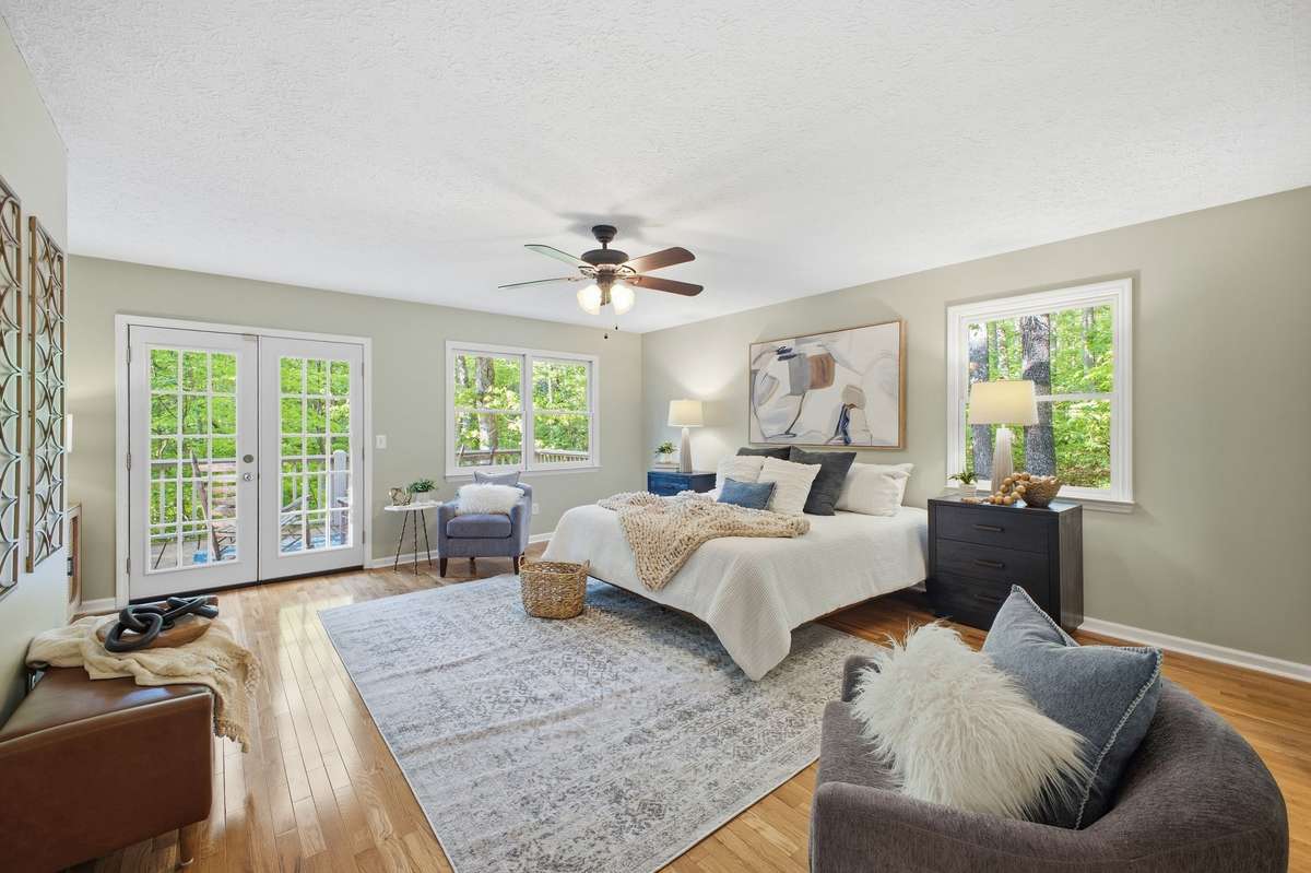 Primary Bedroom with French doors that open to the back deck.