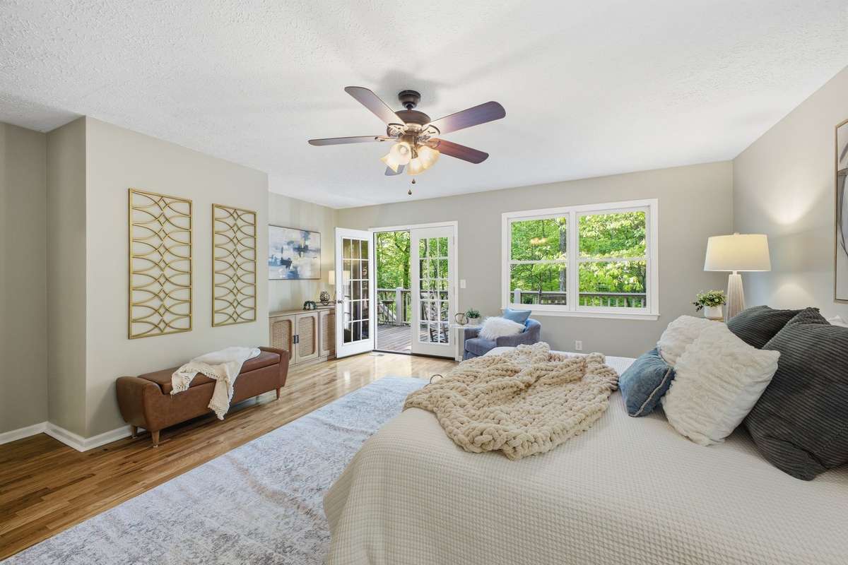 Primary Bedroom with French doors that open to the back deck.