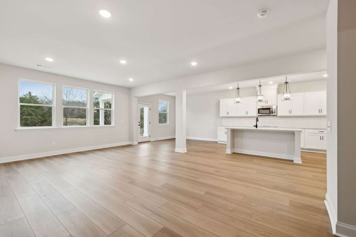 Enjoy peaceful, unobstructed views from the main living area, with large windows that frame the private backyard setting. The natural light and scenery create a warm and inviting atmosphere.