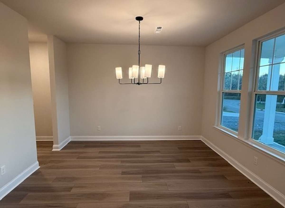 The inviting dining space features a convenient pass-through to the kitchen, enhancing the flow between rooms.