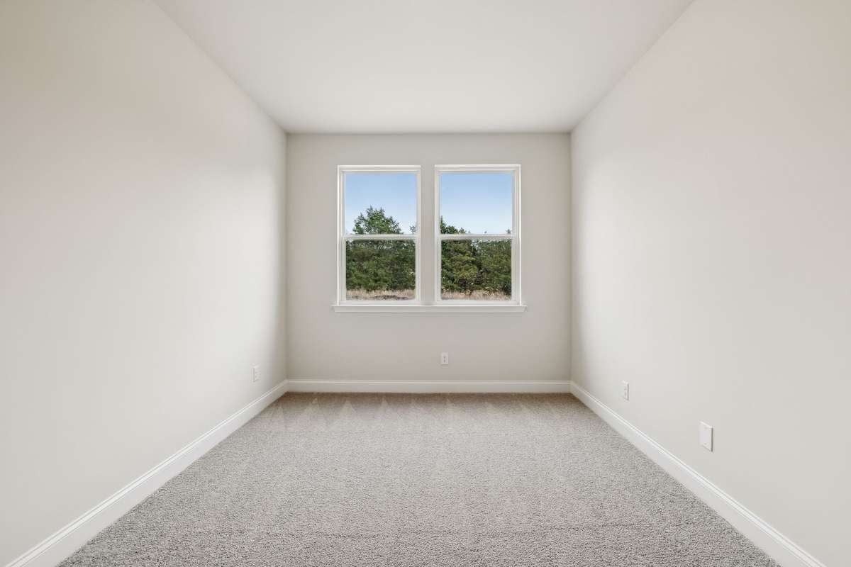 This convenient guest bedroom on the main level offers privacy and flexibility, perfect for visitors, multi-generational living, or a home office.