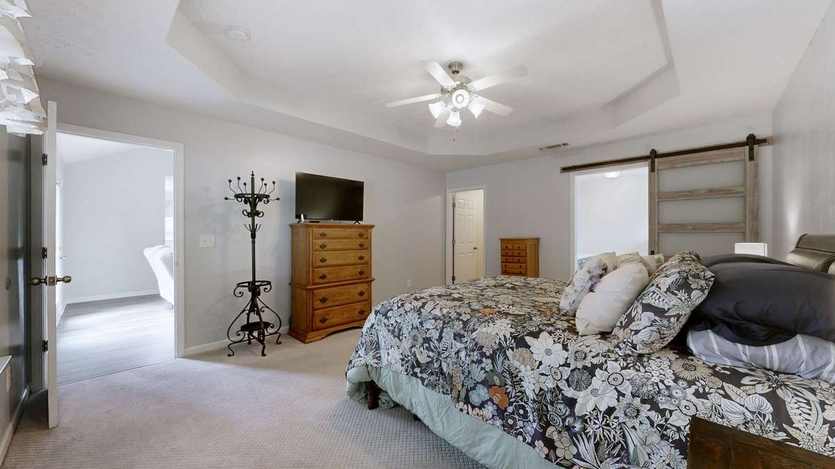 What a stylish barn door leading to the remodeld bathroom.