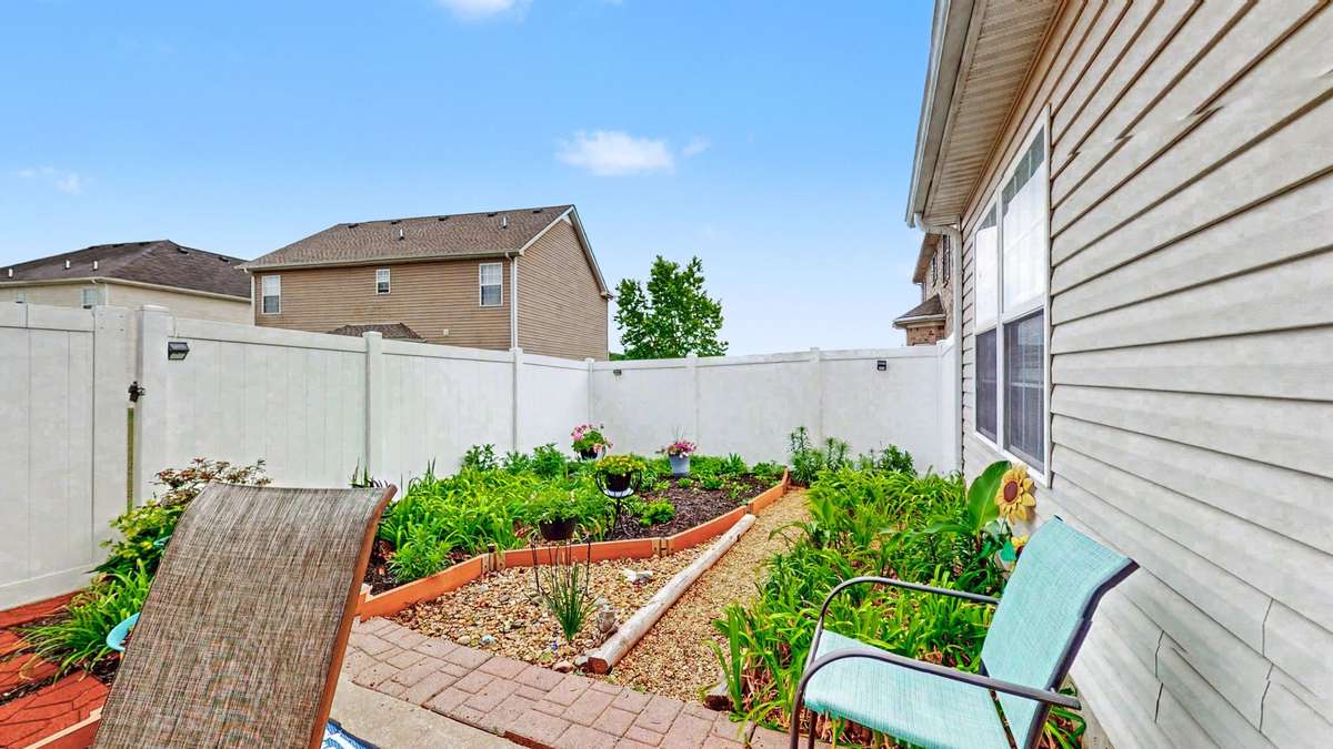Enjoy this amazing landscaping with flowers galore in the back yard!