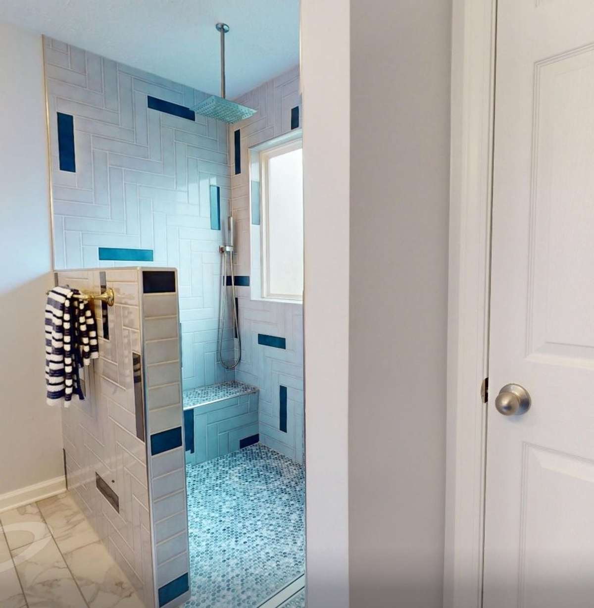 Tiled walk in shower with rain showerhead and handheld shower wand