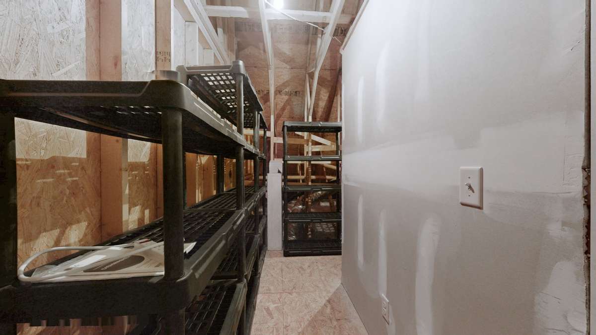 Off the bonus room is a walk-in attic! The seller is leaving the shelving!