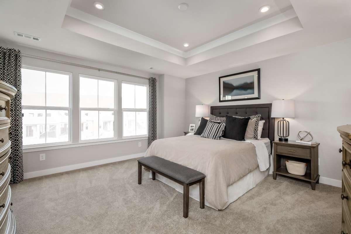 ALL photos are of a model home - Primary bedroom located away from the secondary bedrooms - king size bed shown