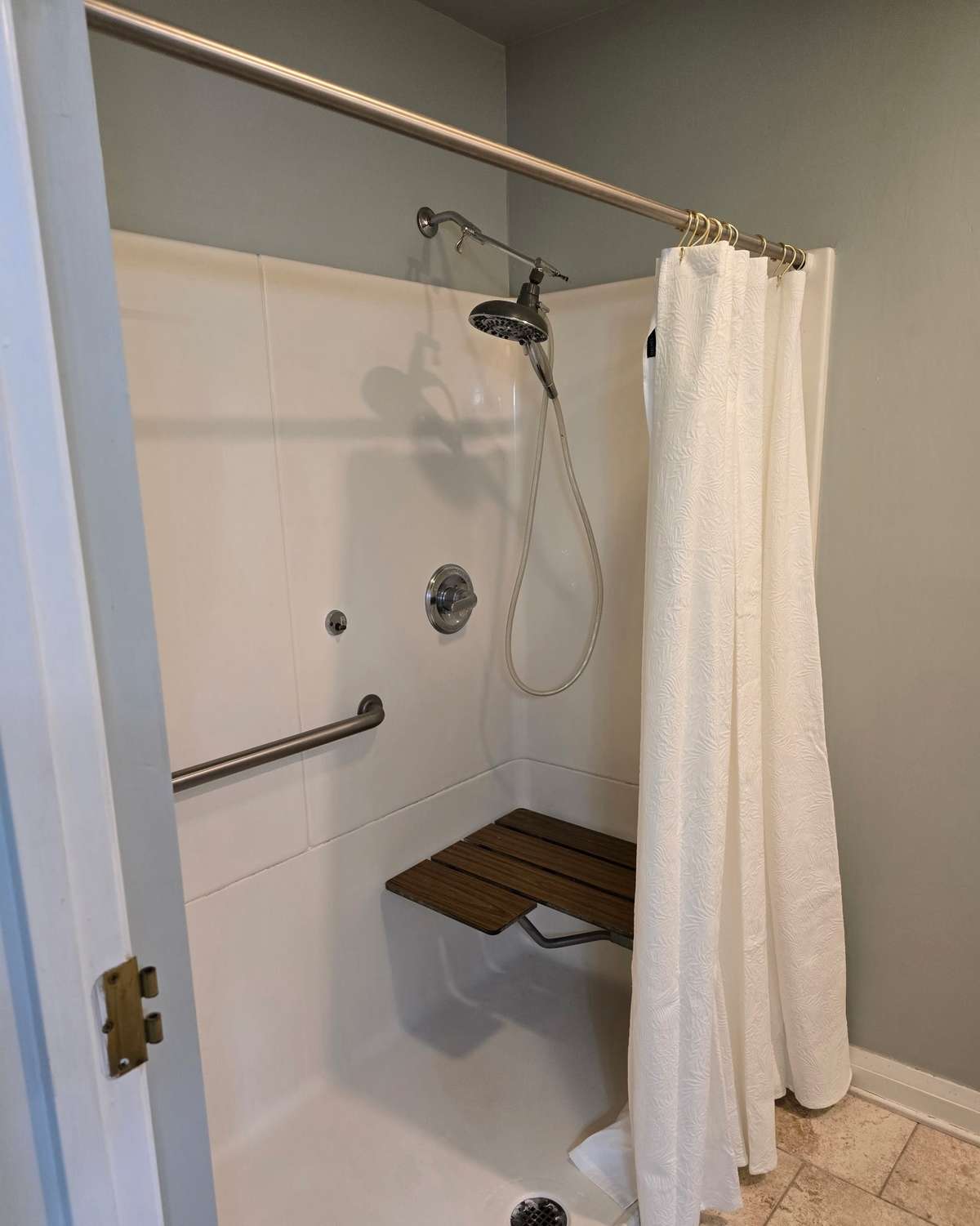 Primary bathroom walk-in shower with seat.