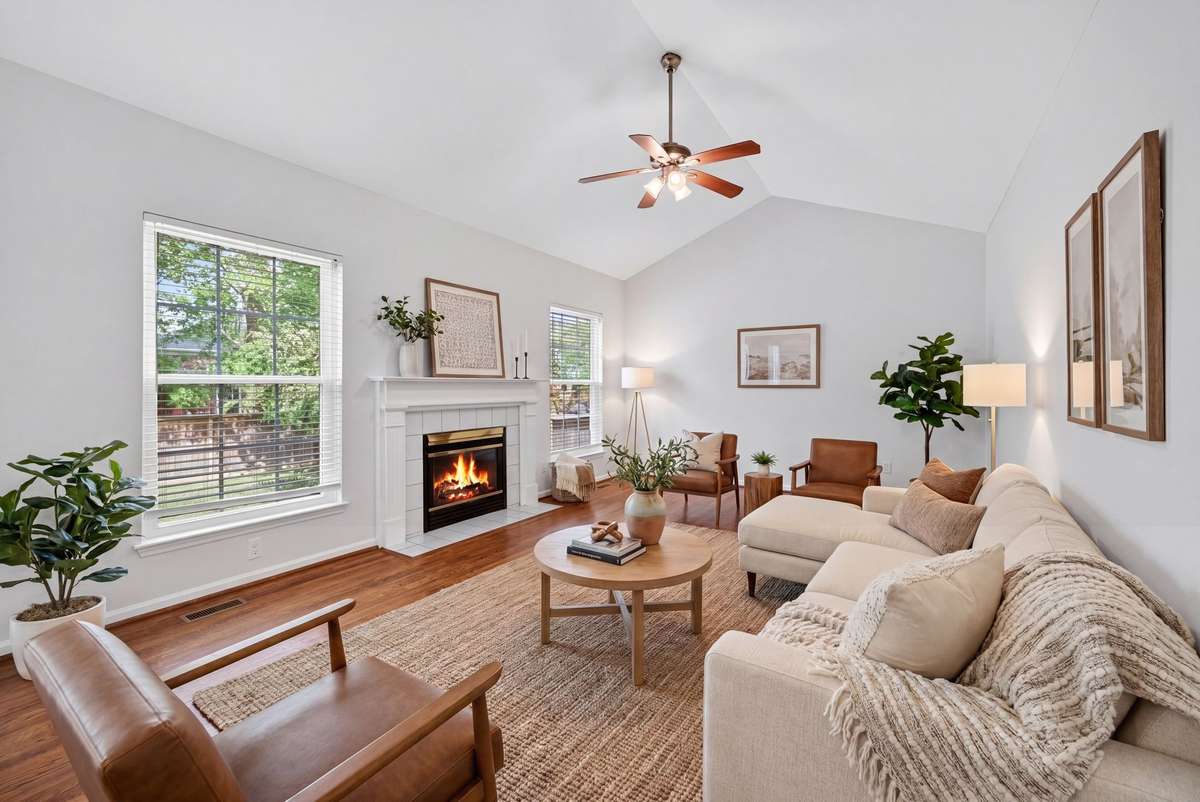 Family room is large with cathedral ceiling and fireplace.  It is off the kitchen making the flow of the home perfect for entertaining.  (Virtually staged)