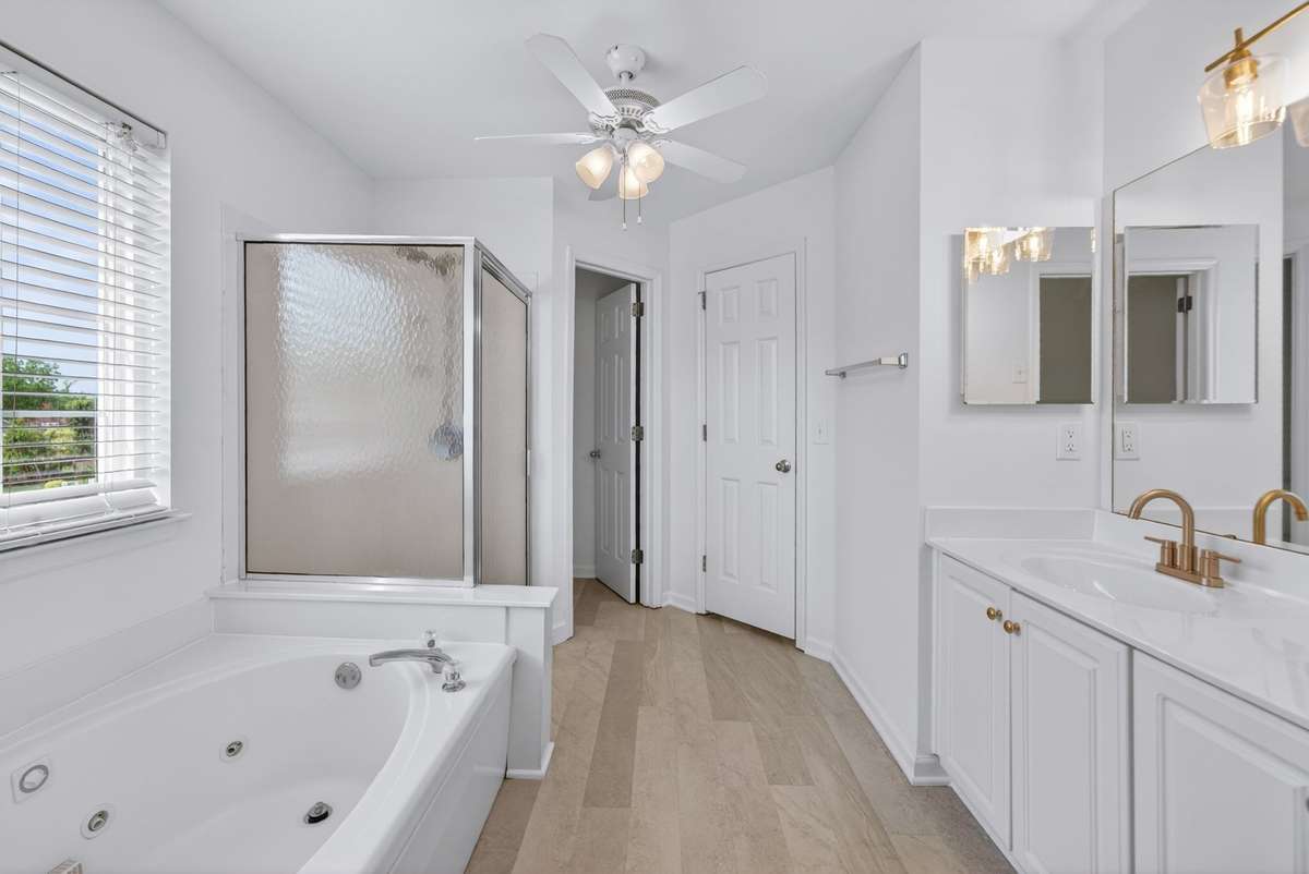 Primary bath has updated two sinks, new plumbing fixtures, separate soaking tub & shower.