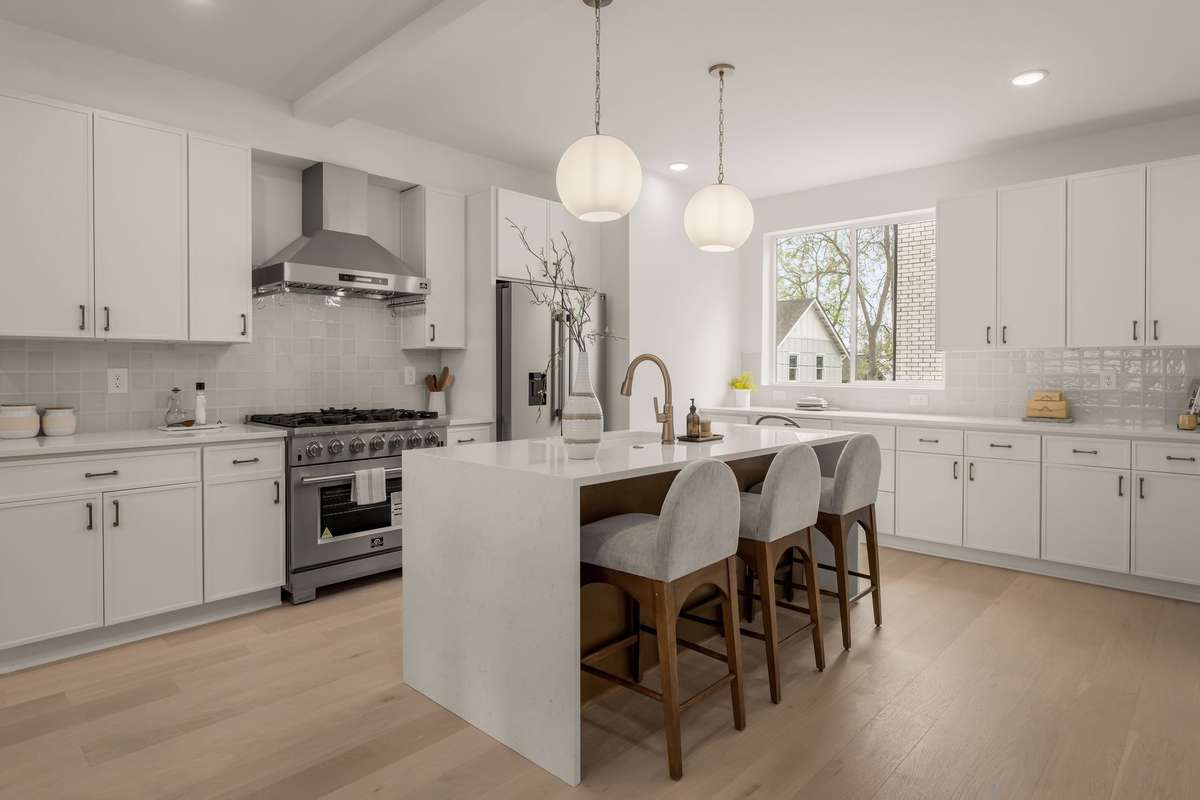 Welcome to the Whitmore - expansive kitchen with waterfall island + gas range