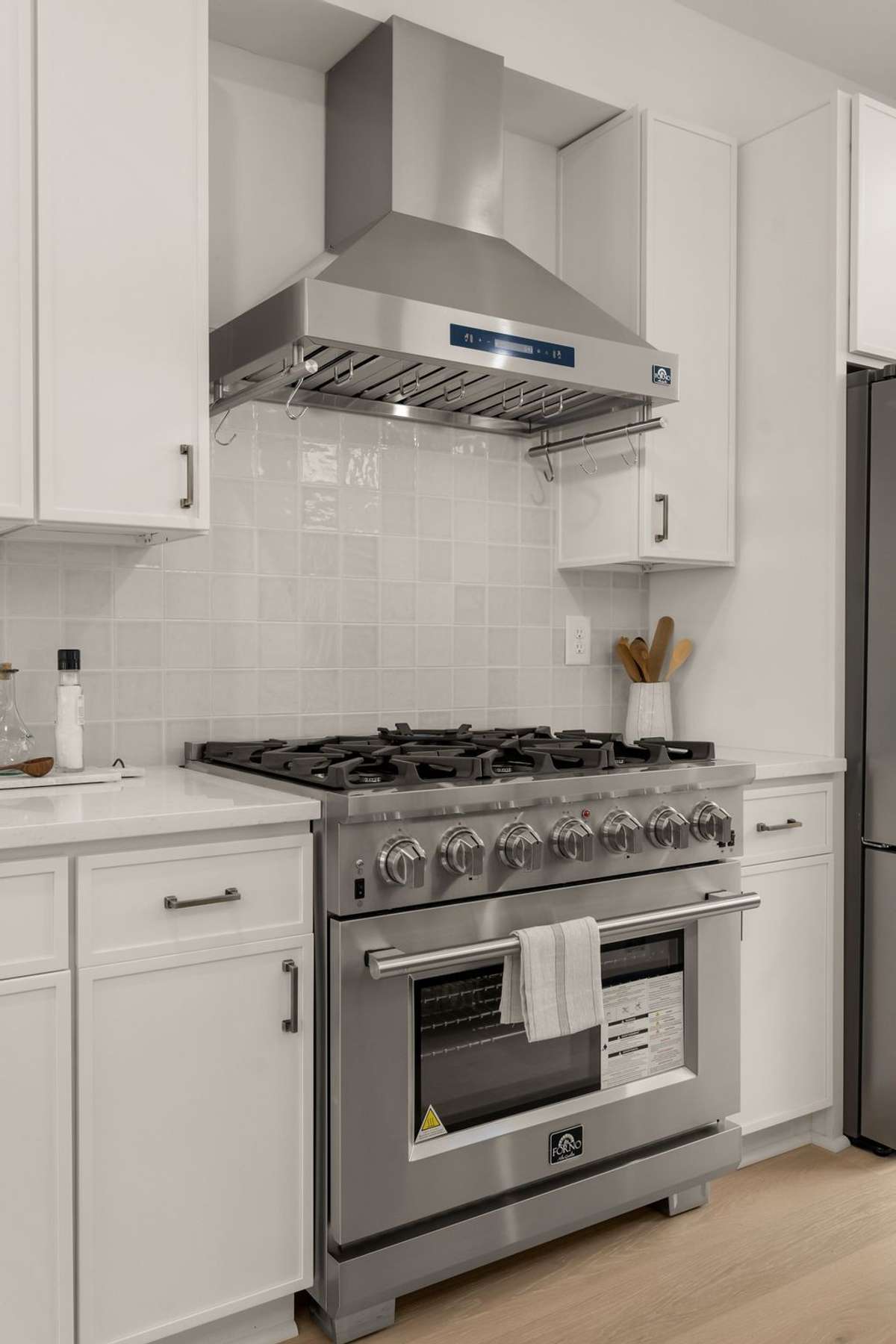 Elevated stainless steel appliances throughout
