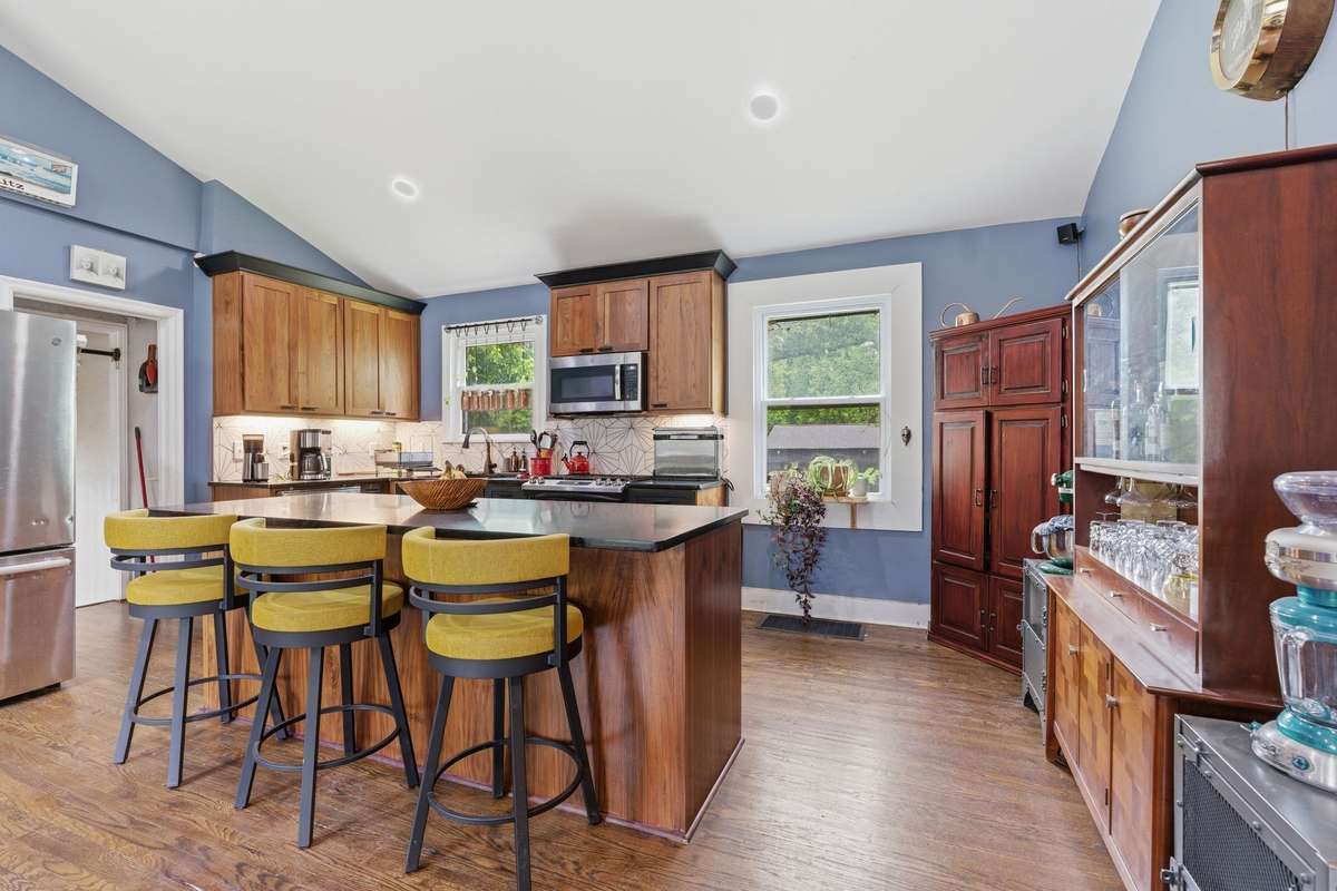 Gas range and other kitchen appliances remain.