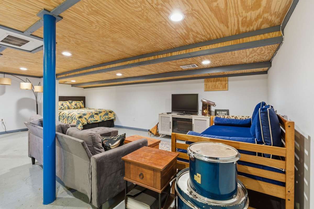 The lower level has a large open space. It is currently being used as a bedroom suite.