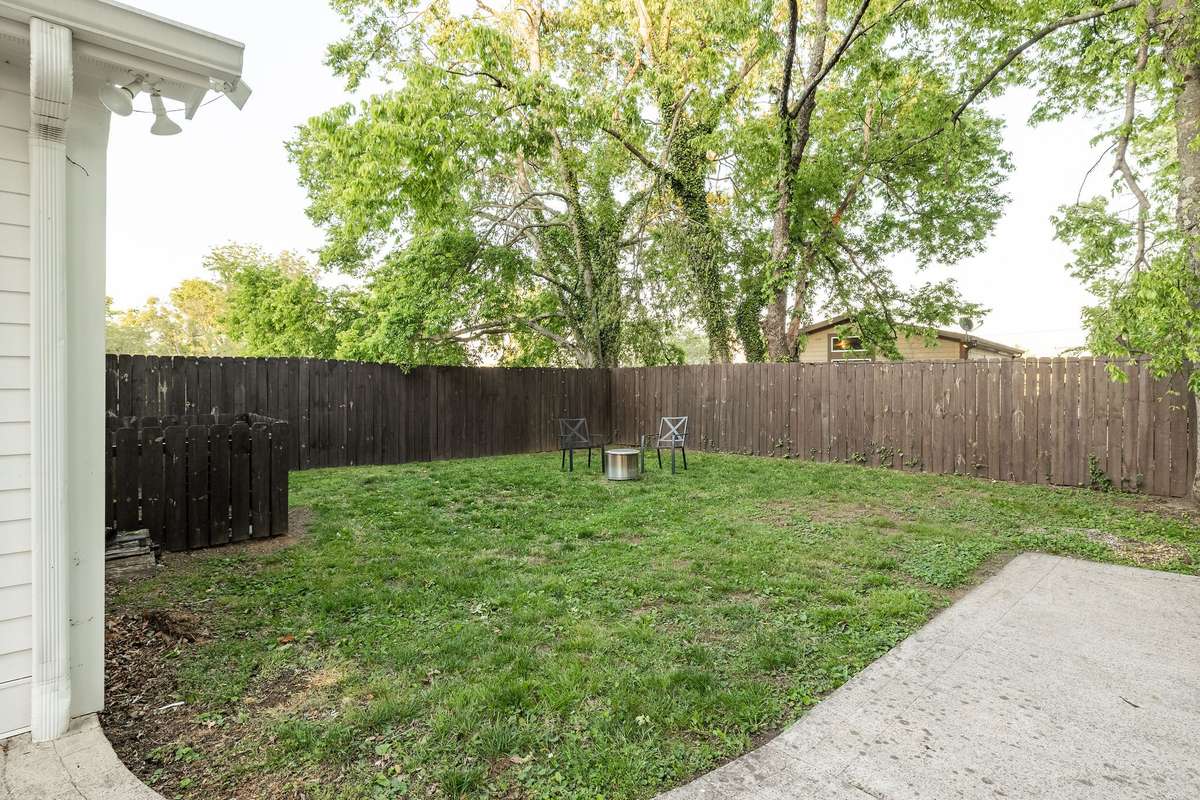 verdant and fenced backyard. The lot goes beyond the fence line