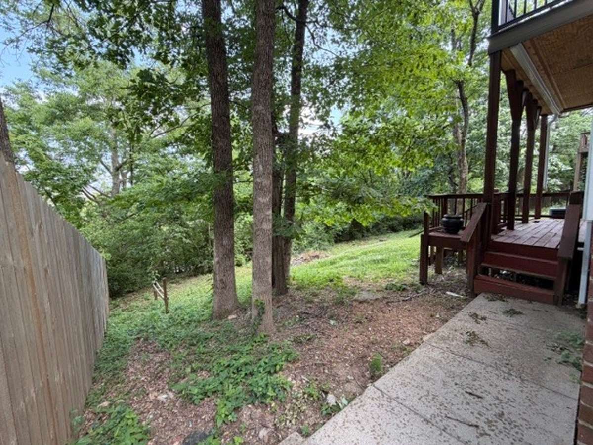 View from stairs on the left side of the home, leading to the basement porch and back door.
