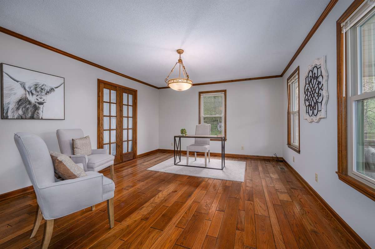 The large room to the right of entry can be used as a formal living room, office, or flex space