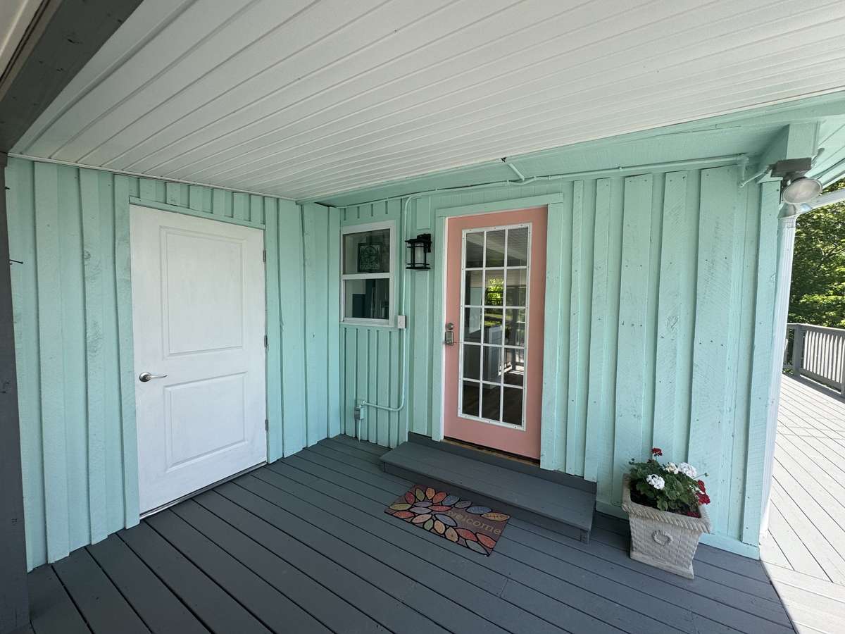 Covered area of deck and separate utility room that is heated and cooled.