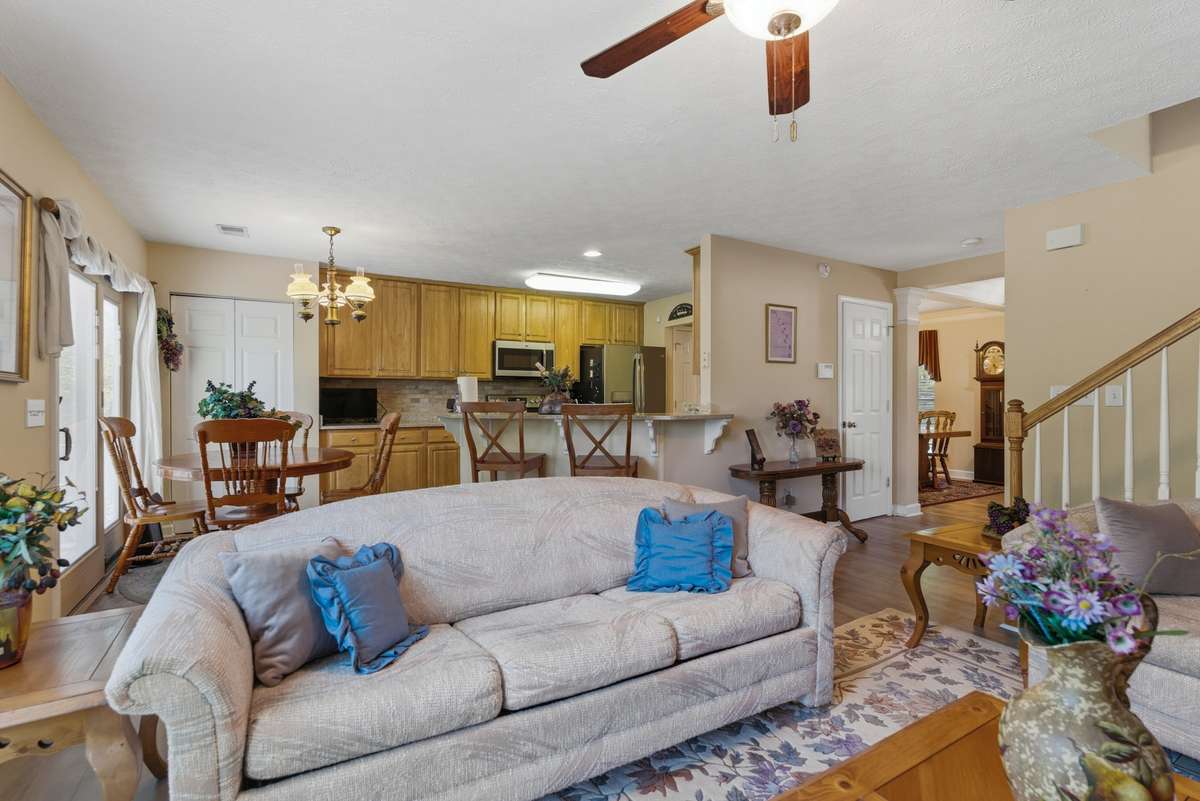 The Great room equipped with a ceiling and close proximity to grab snacks and enjoy the fireplace or the television.
