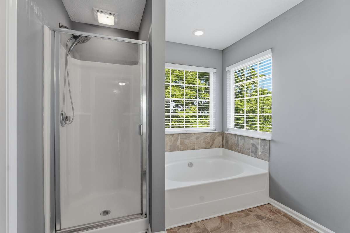 Garden tub and separate shower with double vanities.