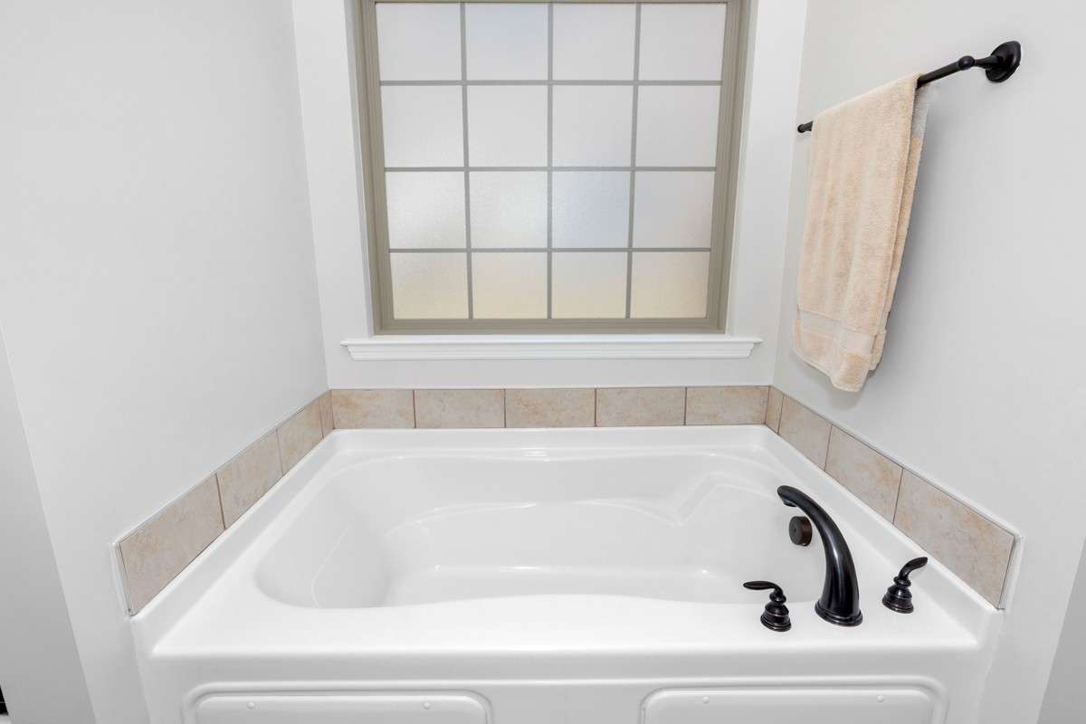 Primary Bathroom -tile flooring, granite double vanities, walk in closet, separate shower, whirlpool