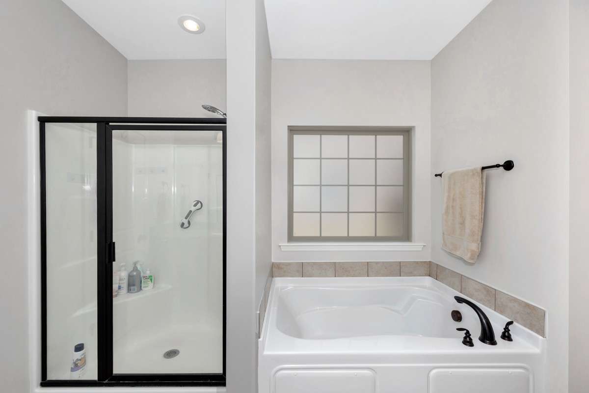 Primary Bathroom- tile flooring, granite double vanities, walk in closet, separate shower, whirlpool