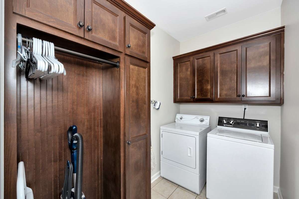 Laundry Room - tile flooring, washer/dryer connections, custom cabinetry