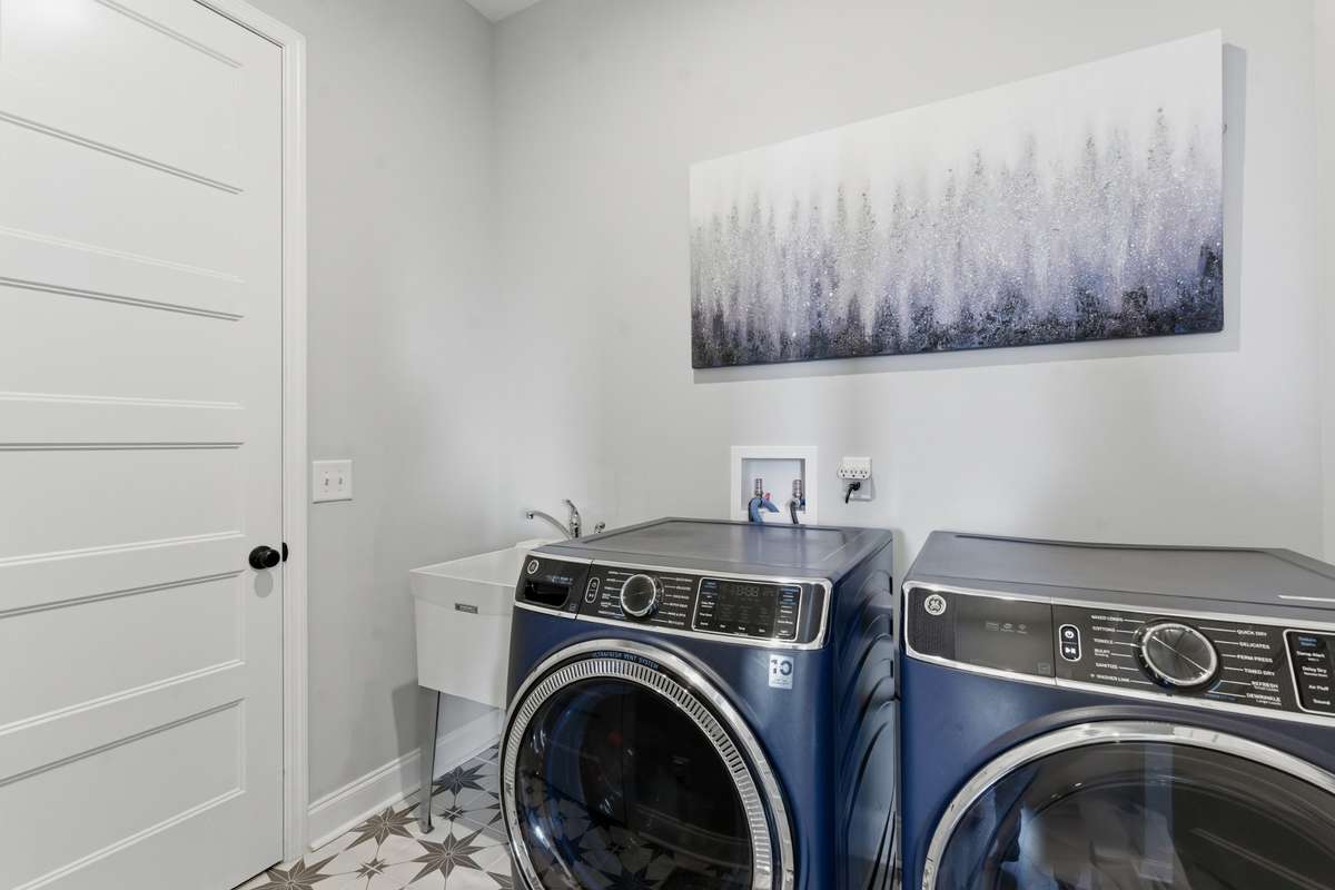And just nearby is your laundry room, tucked away with a utility sink and plenty of room to actually make laundry feel manageable.