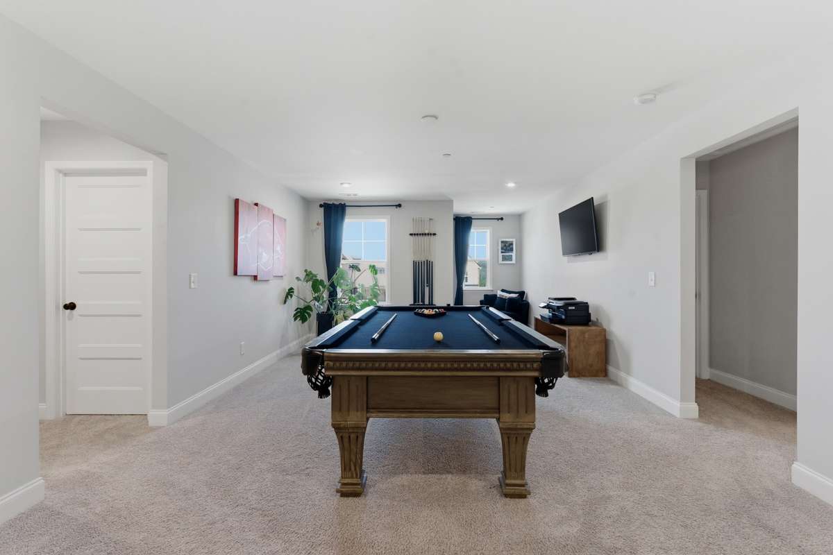 Heading upstairs, the spacious bonus room offers the perfect central hangout.